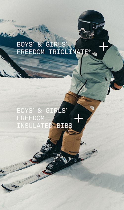 Child skiing down a mountain wearing Freedom Triclimate and Freedom Insulated bibs.