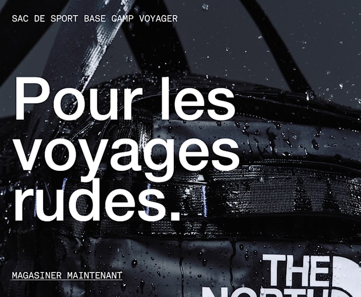 A black duffel with water bouncing off of it. 