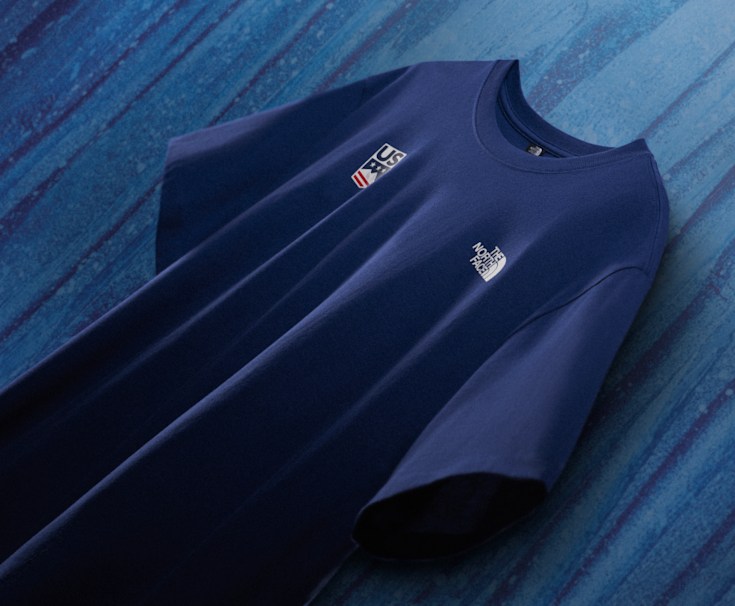 North Face x US Ski & Snowboard shirt on a blue background