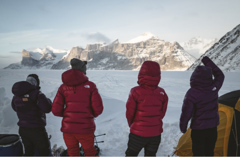 Emily Harrington, Brette Harrington, Christina Lusti and Hilaree Nelson face away from the camera towards the sun.