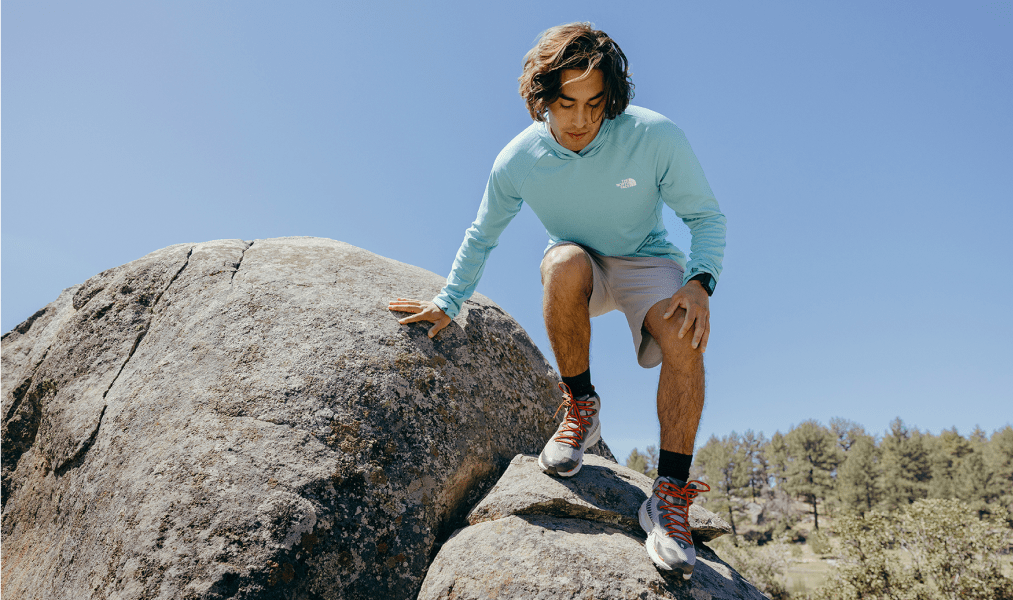 Person climbing down a rock.