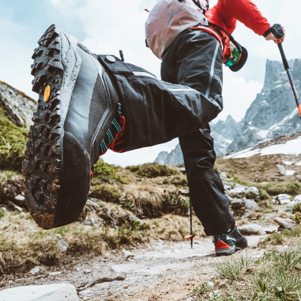 Close up of The North Face hiking boots on a person speeding through the mountains.