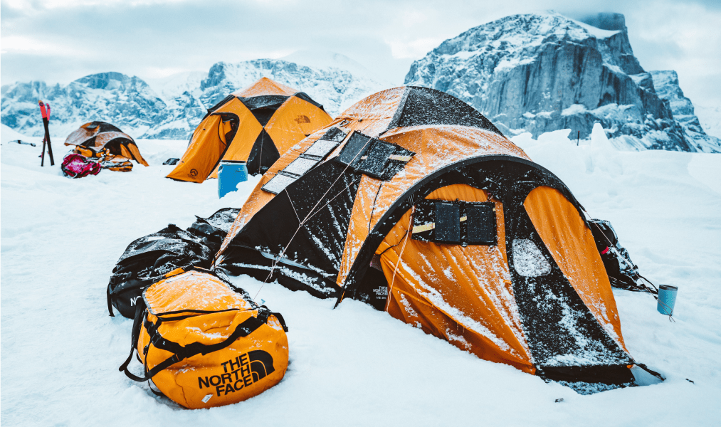 image of a snowy north face tent on a mountain top