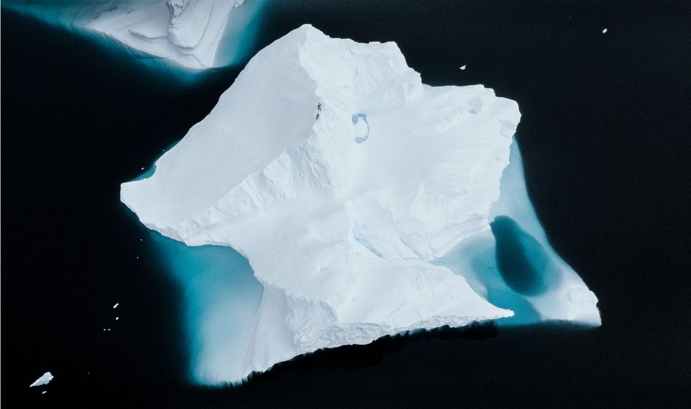 Photo of an iceberg against dark water