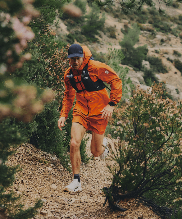 A man runs up a mountain wearing apparel from The North Face.