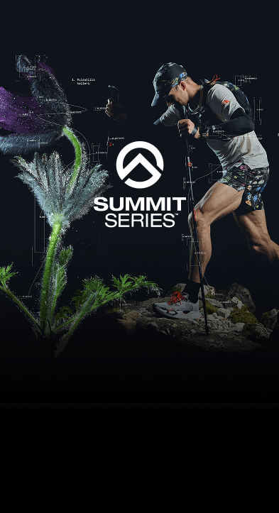 A tall purple flower gently bending to the left. An image of a woman standing straight up in trail gear next to it.