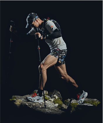 A hiker in The North Face gear sits on a rock.