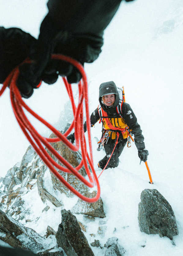 Image of a climber from The North Face scaling an ice wall.