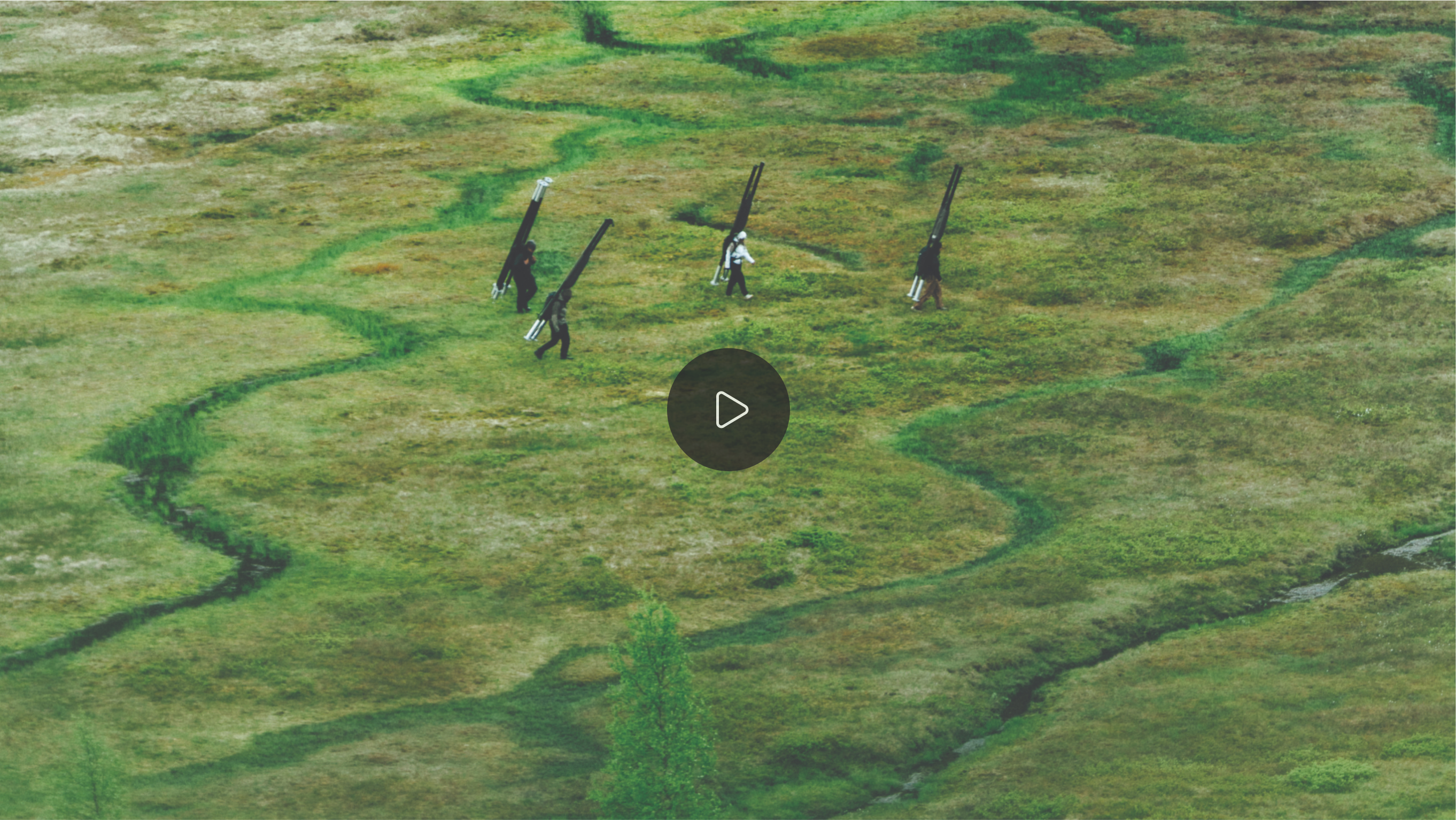 Video still with interactive play button.
