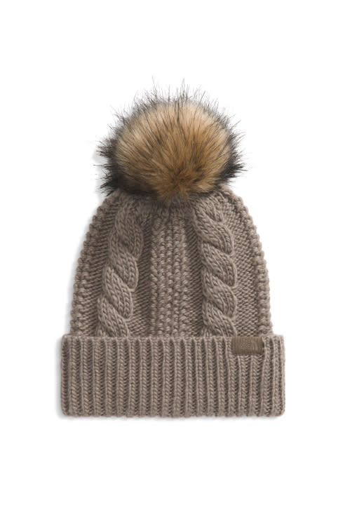 Tan knit beanie with pom pom.