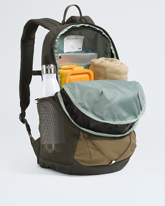 A beige backpack is open, showing how it can fit a lunchbox, sweater, laptop and water bottle.