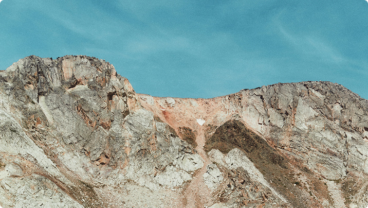 An image of mountain tops and blue sky.